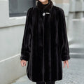 Women's black A-line faux-fur stand-collar coat, front view