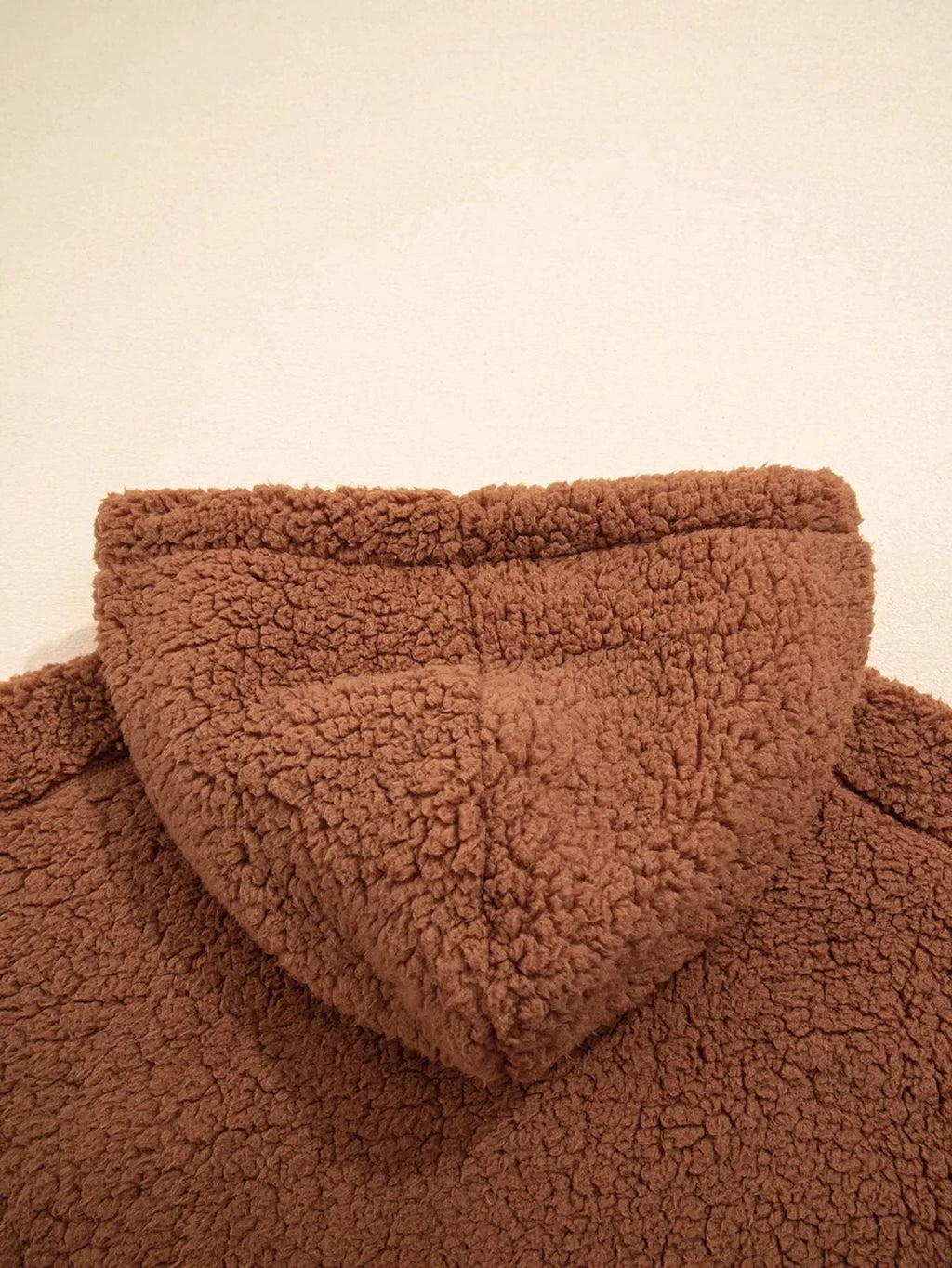 Back close-up of attached hood on women's brown teddy jacket