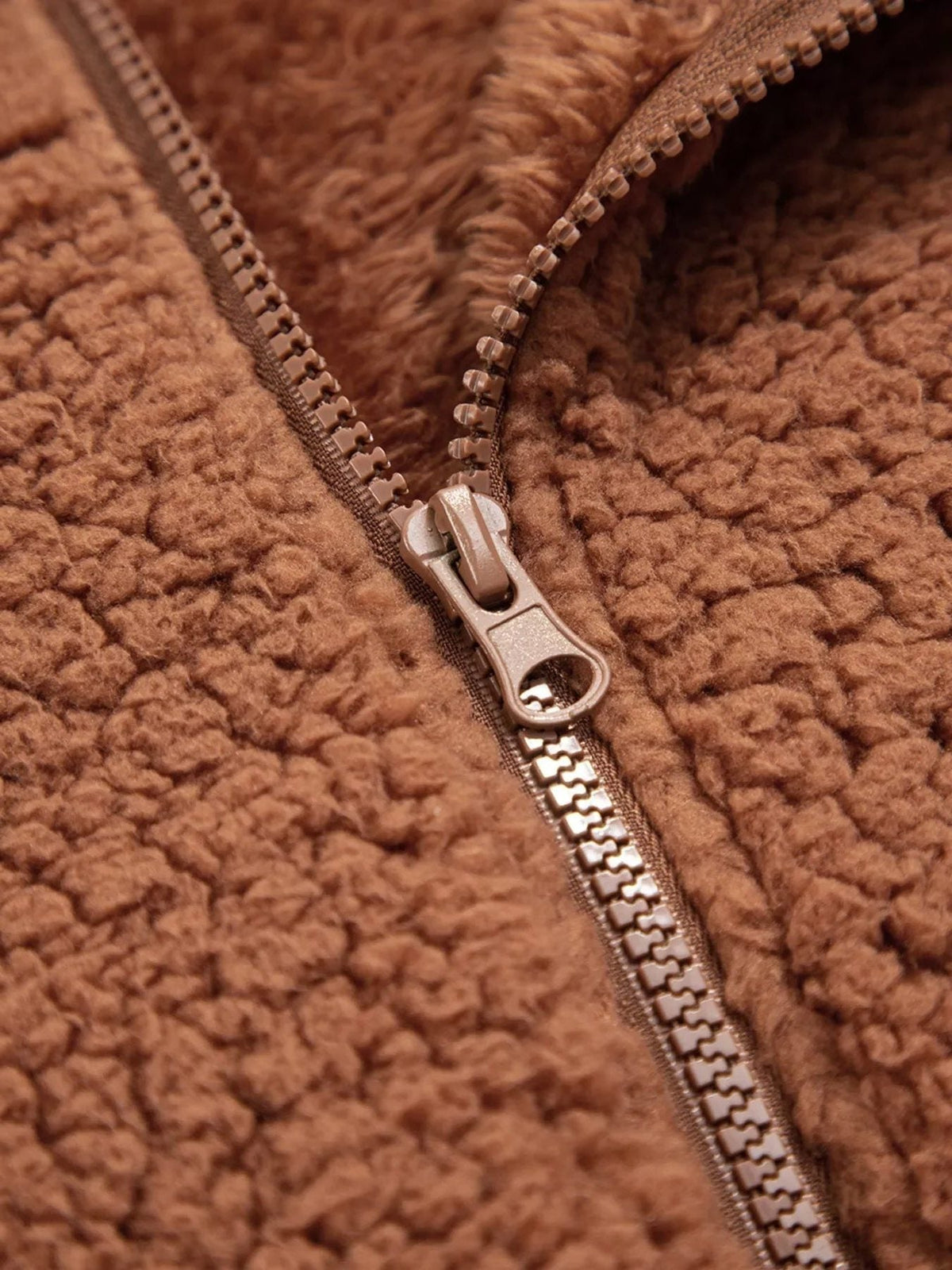 Close-up of zipper on women's brown teddy jacket