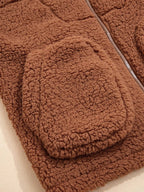 Close-up of rounded patch pocket on women's brown teddy jacket