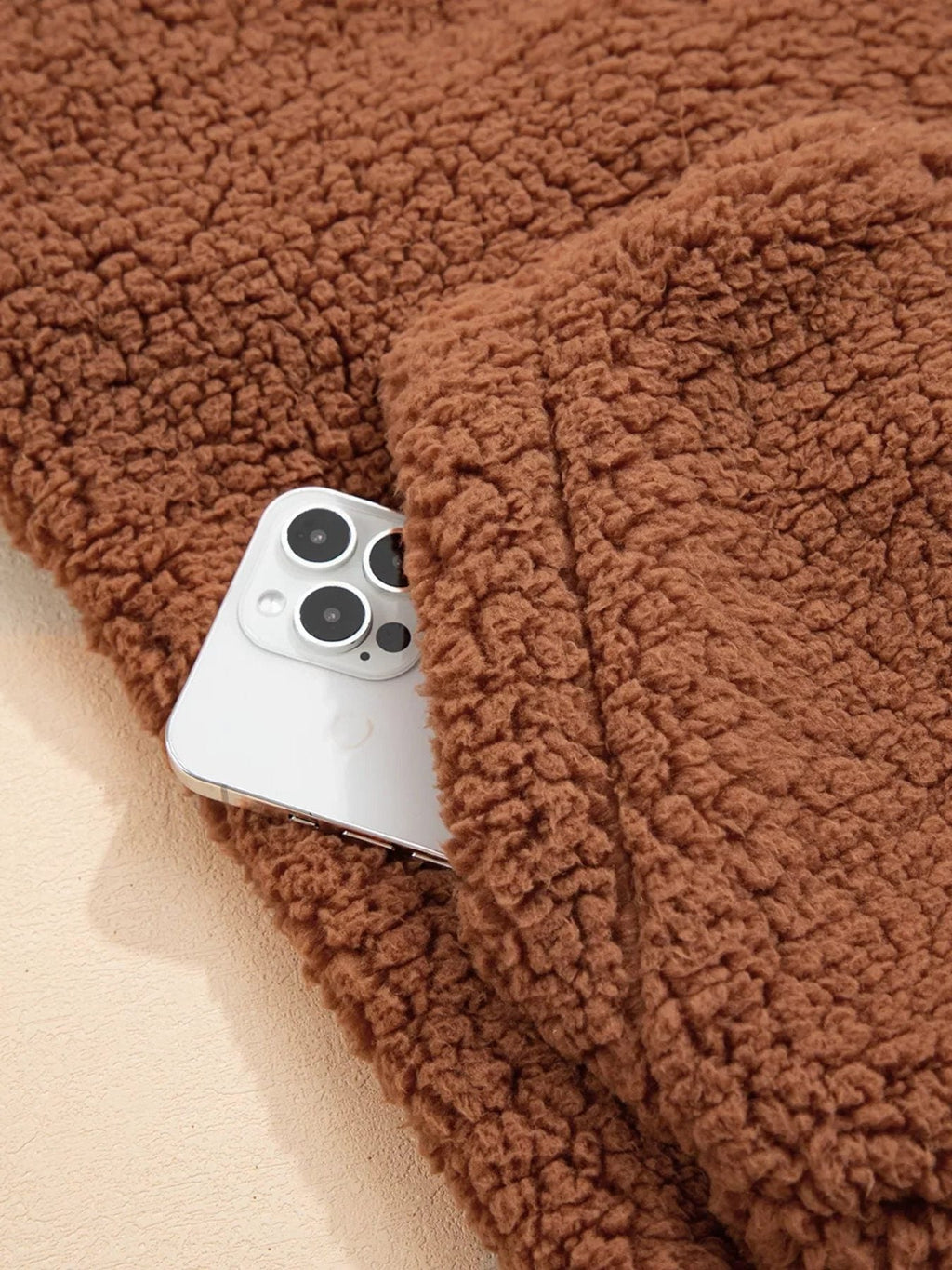 Close-up of usable front pocket on women's brown teddy jacket