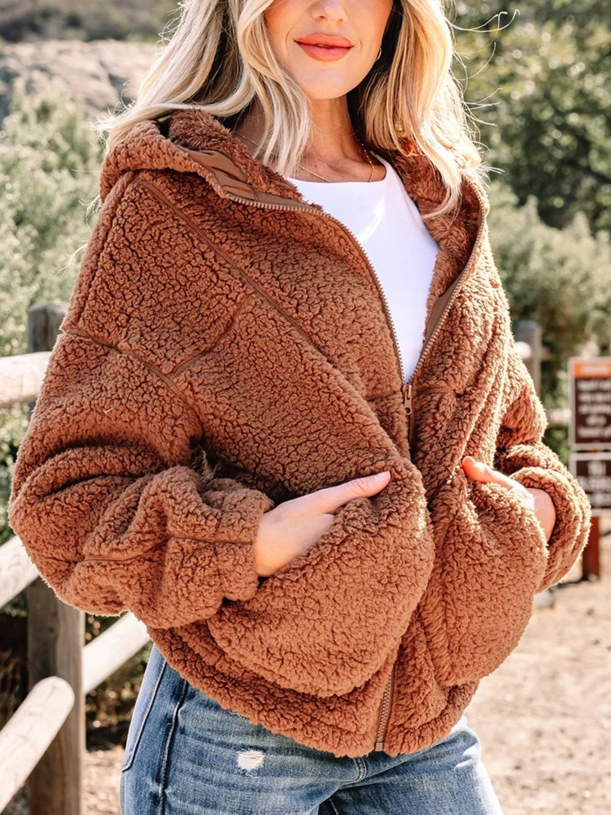 Women's brown oversized hooded teddy zip-up jacket, angled view