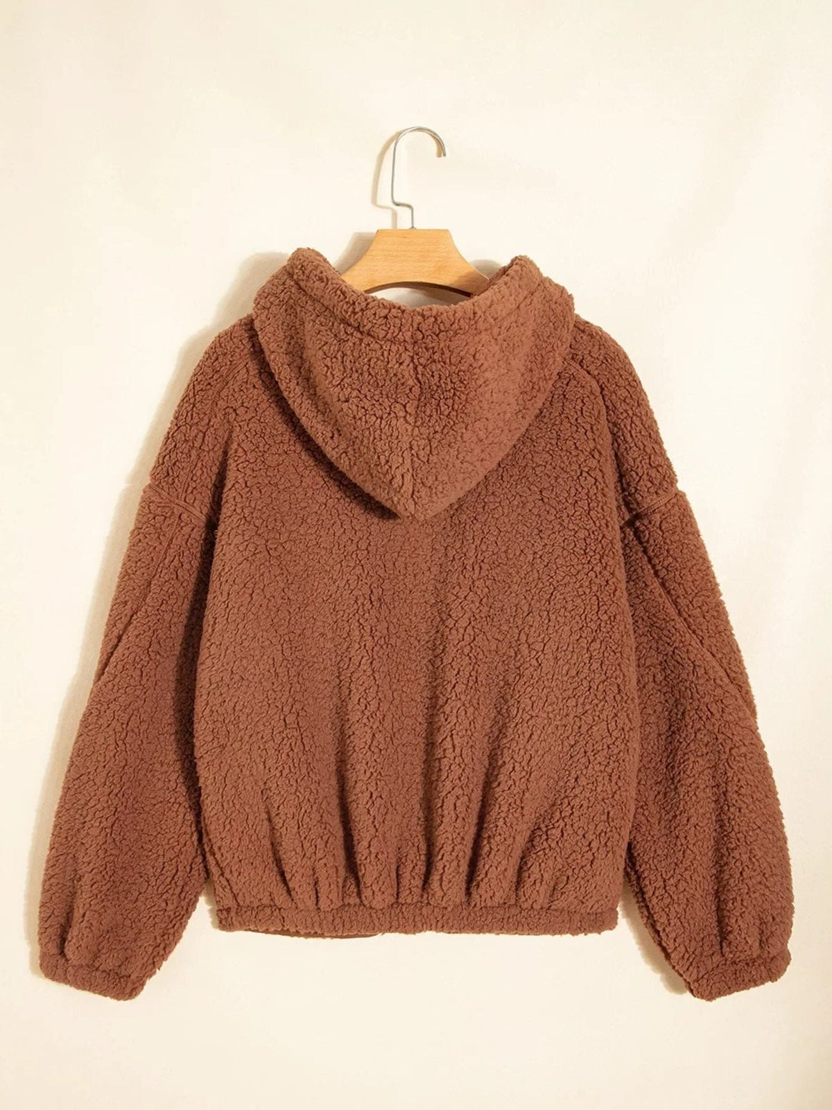 Back view of women's brown hooded teddy zip-up jacket on a hanger