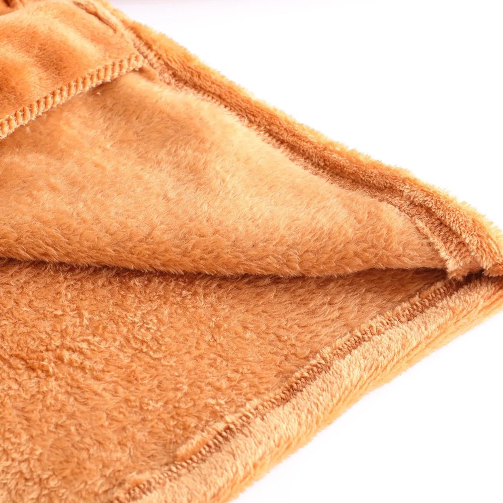 Close-up of front edge and plush texture on women's brown coat