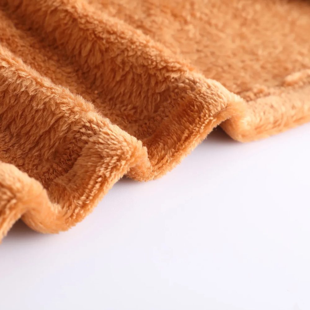 Close-up of hem and plush texture on women's brown coat
