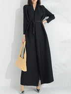 Women's black long-sleeve wrap maxi coat dress with tie belt, front view